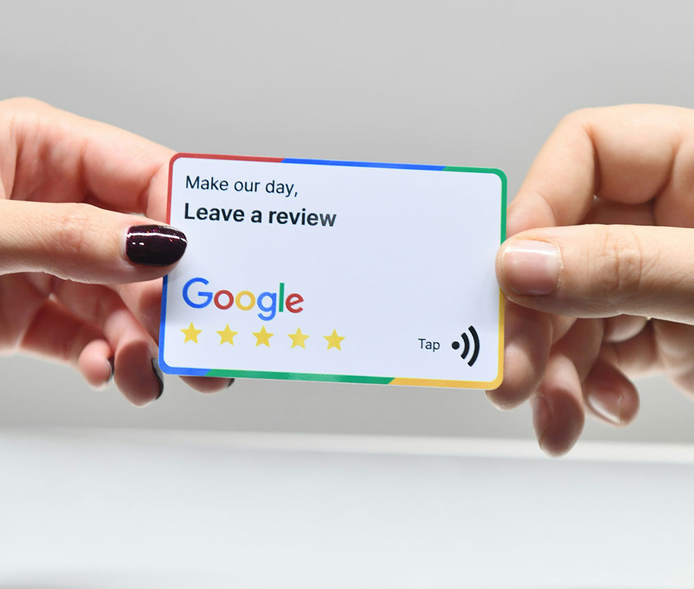 2 hands passing a business card with the text 'Make our day, leave a review - Google'